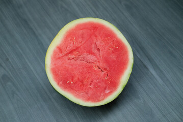 slices of red watermelon on a wooden background