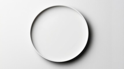 Contemporary white plate on a white surface, top-down perspective, sharp edges and subtle texture details, ultra-clean minimalism