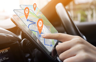 Person using  GPS navigation app on a smartphone in a car, with food location pins displayed on the screen. Ideal for concepts of technology in travel, food delivery