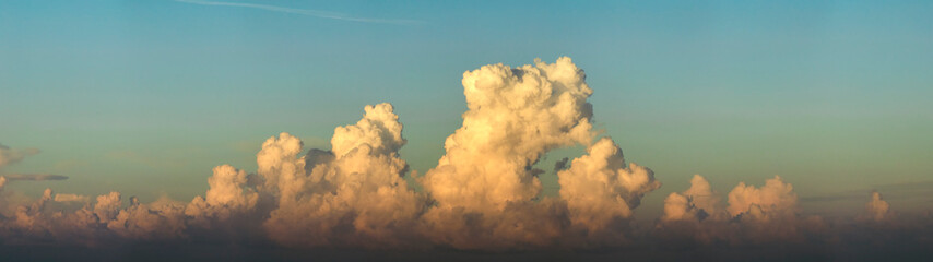 Bright colorful orange and yellow clouds on horizon. Beautiful sunset sky scenery