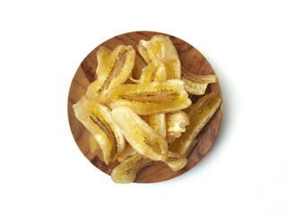 Kripik pisang or sweet banana chips on plate isolated on white background with top view angle setup 