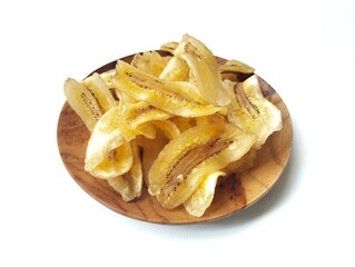 Kripik pisang or sweet banana chips on plate isolated on white background with high angle view setup 