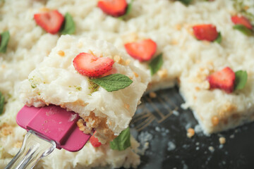 A delicious dessert featuring strawberries and coconut topped with a refreshing mint garnish