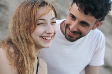closeup portrait of cute loving young couple on the beach