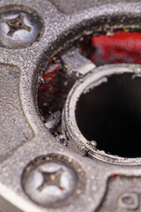 A close-up of a threading die, also known as a pipe die, used for cutting threads on steel pipes, with visible teeth and metallic finish.