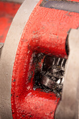 A close-up of a threading die, also known as a pipe die, used for cutting threads on steel pipes,...