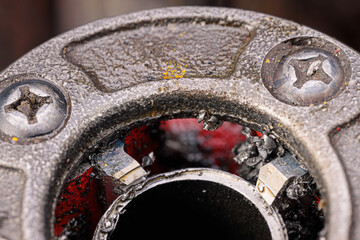 A close-up of a threading die, also known as a pipe die, used for cutting threads on steel pipes,...