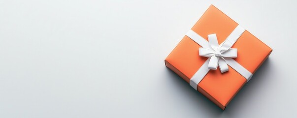 A vibrant orange gift box with a white ribbon on a minimalistic background, perfect for celebrations.