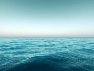 Fototapeta premium A serene view of calm ocean waters at dawn, featuring gentle waves under a pastel sky, creating a tranquil and peaceful atmosphere.