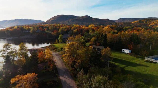 Cape Smokey Mountains along Ingonish Beach, Cabot Trail, Cape Breton, Nova Scotia, Canada. Incredible blue ocean waters with  the autumn fall foliage colors.  [Vertical Video]