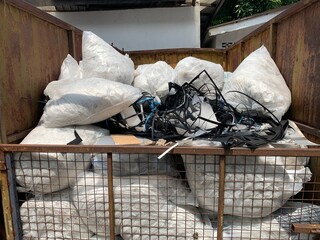 close up of a  garbage sacks in a large iron basket