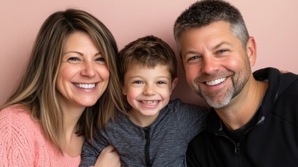 A smiling family portrait featuring a mother, father, and son.