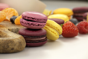 Vibrant scene of table filled with macaroons and fruits