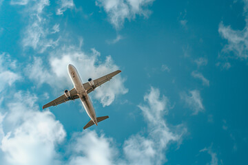  Passenger airplane soaring through a vibrant blue sky, symbolizing adventure and exploration