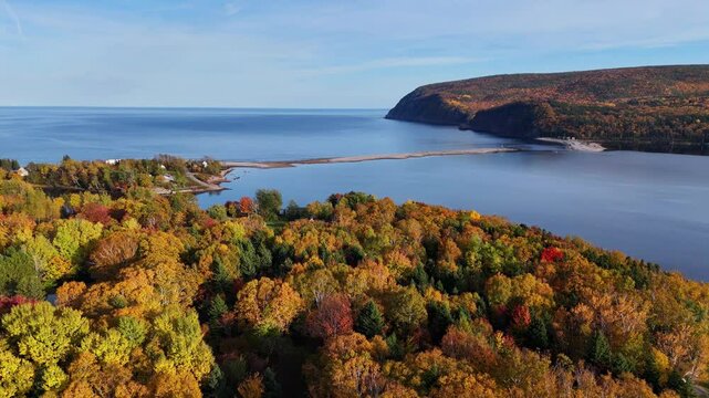 Ingonish Beach along Cabot Trail, Cape Breton, Nova Scotia, Canada. Incredible blue ocean waters with  the autumn fall foliage colors. 