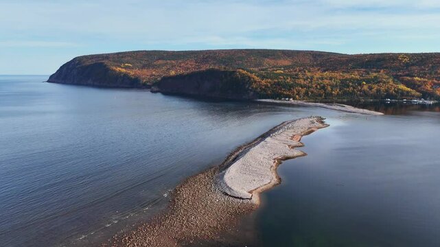 Ingonish Beach along Cabot Trail, Cape Breton, Nova Scotia, Canada. Incredible blue ocean waters with  the autumn fall foliage colors. 