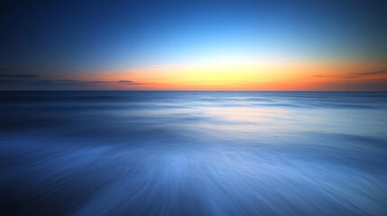 A serene seascape at dusk, showcasing tranquil water and a colorful sky.