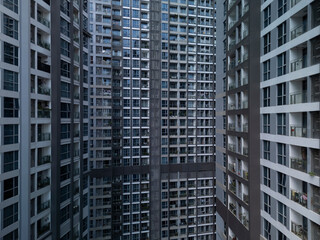 Fototapeta premium Modern luxury high-rise buildings in dramatic light showing density and height of large construction project in landscape format.