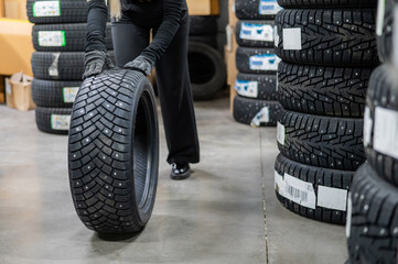 Fototapeta na wymiar Mechanic keeps new studded car tires in garage. 