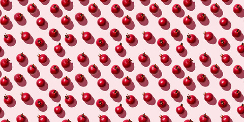 A seamless pattern of pomegranates, each with its shadow, scattered across the canvas in an elegant display, with soft shadows on a soft pale pink color background