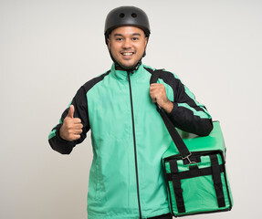 Young asian rider wearing green jacket uniform and bike helmet various action with delivery box. Male delivery service worker. Courier and shipping food service to customer online application