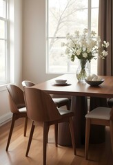 A cozy dining room with a wooden table and chairs, a vase of white flowers, and a framed artwork on the wall.