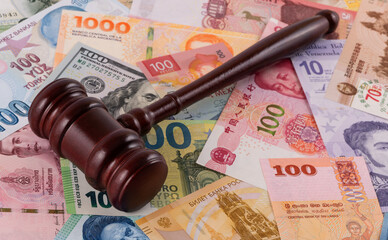 Judge's gavel and banknotes from different countries of the world of different denominations