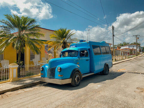 Large blue vintage truck parked outside a house in Vinales, Cuba. Many vintage vehicles are restored, converted into colectivos (local taxi) where different passengers ride together at the same time.