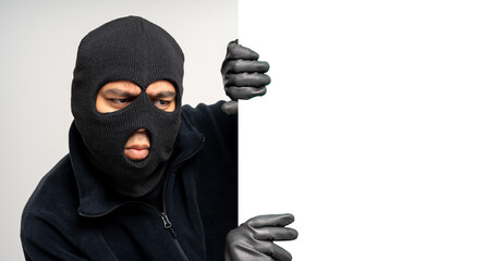 Thief in uniform black jacket various pose on isolated background. The Robber terrorism criminal escapes with balaclava and crowbar entering a house for stealing Housebreak