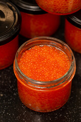 Jars of red caviar, freshly salted caviar at home