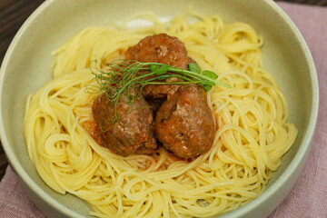 A plate of spaghetti pasta with meatballs