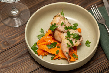 A portion of baked sweet potato slices with baked quail
