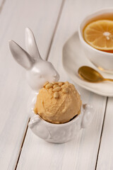 A ball of natural craft lemon ice cream with pine nuts.