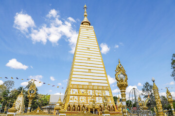 Naklejka premium Wat Phra That Nong Bua, Ubon Ratchathani, inside there is the Phra That Sri Maha Bodhi Chedi, a replica of the Chedi in Bodh Gaya, India, stucco sculptures, candles, and two large Naga statues.