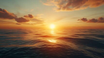 Obraz premium The sun is setting over the ocean, casting a warm glow on the water