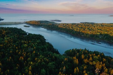 Obraz premium The calm Branch estuary, forest and coastline at sunsrise, Phippsburg, Maine, United States.