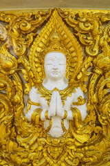 Fototapeta premium Wat Phra That Nong Bua, Ubon Ratchathani, inside there is the Phra That Sri Maha Bodhi Chedi, a replica of the Chedi in Bodh Gaya, India, stucco sculptures, candles, and two large Naga statues.