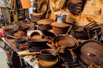 Rusted iron pots and pans for sale in an Antique store in Searsport, Maine, United States.