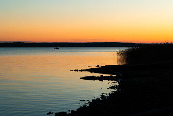 Fototapeta premium Beautiful early autumn sunrise at the lakeside in Latvia. Seasonal scenery of Northern Europe.