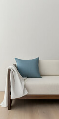 Cozy living room with a wooden sofa and soft blue pillow during daylight hours