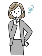 腰に手を当てて悩むスーツ姿のビジネスウーマン女性