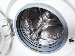 The drum of the washing machine in close-up. Repair, cleaning. Laundry. The background for the advertisement, the place for the text. 