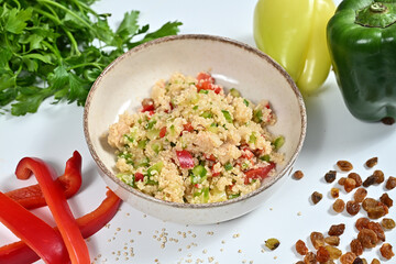 some fresh vegetables are lying out on a white surface including peas, peppers, and