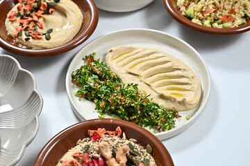 different plates filled with various foods on a table by some utensils