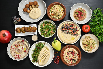 a variety of bowls of food sit on top of a black table