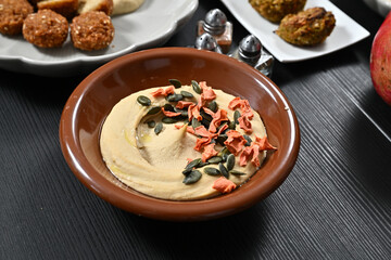 there is a bowl with some food on the table in front of it