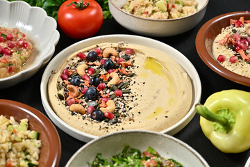 food is arranged on a table in bowls and plates with vegetables