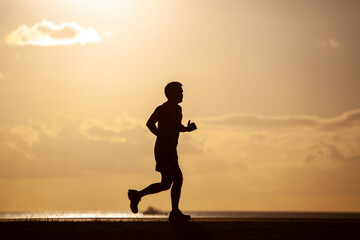 Silhouette of Man Running at Sunset