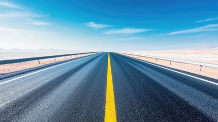 Fototapeta premium Endless straight road under a blue sky, minimalistic and open landscape.