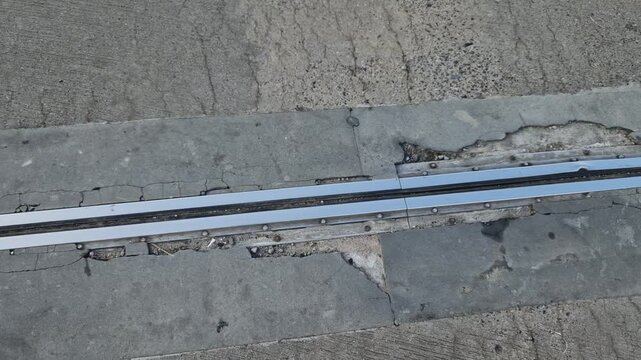 roof structure or bridge expansion for safe connection of two expandable concrete bodies. rubber joint in a metal bar, cracked, eroded, video, curb, renovation frost, salt, crack, crushed